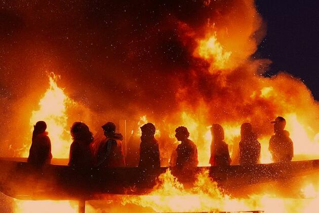 Moygashel bonfire topped with migrant effigy lit