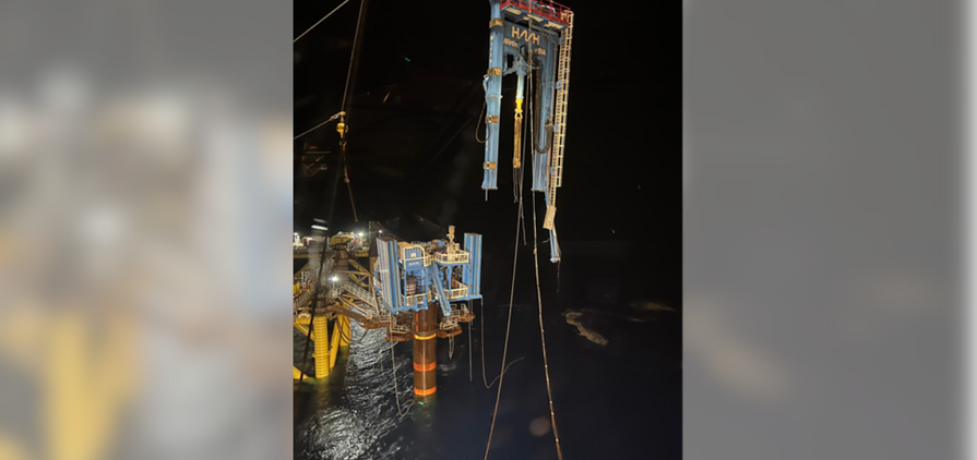 The broken off drilling rig dangles in the after the incident