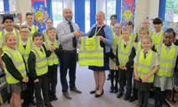 Covers donates high-vis vests to junior school