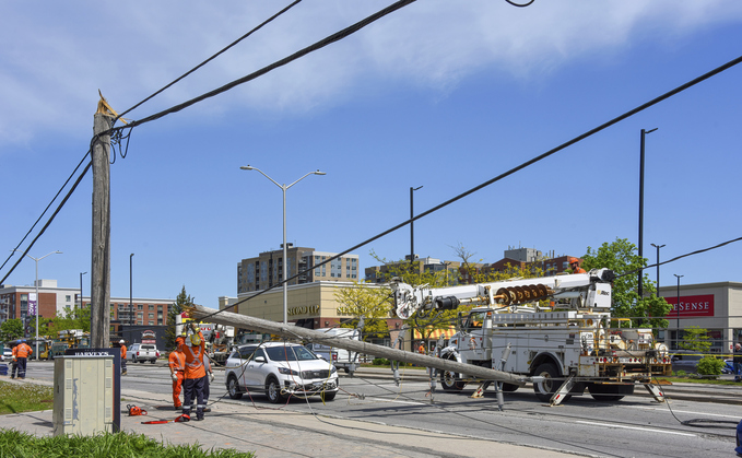 Hydro workers repairing downed power pole snapped during severe storm in Ottawa, Canada, in May 2022 | Credit: iStock