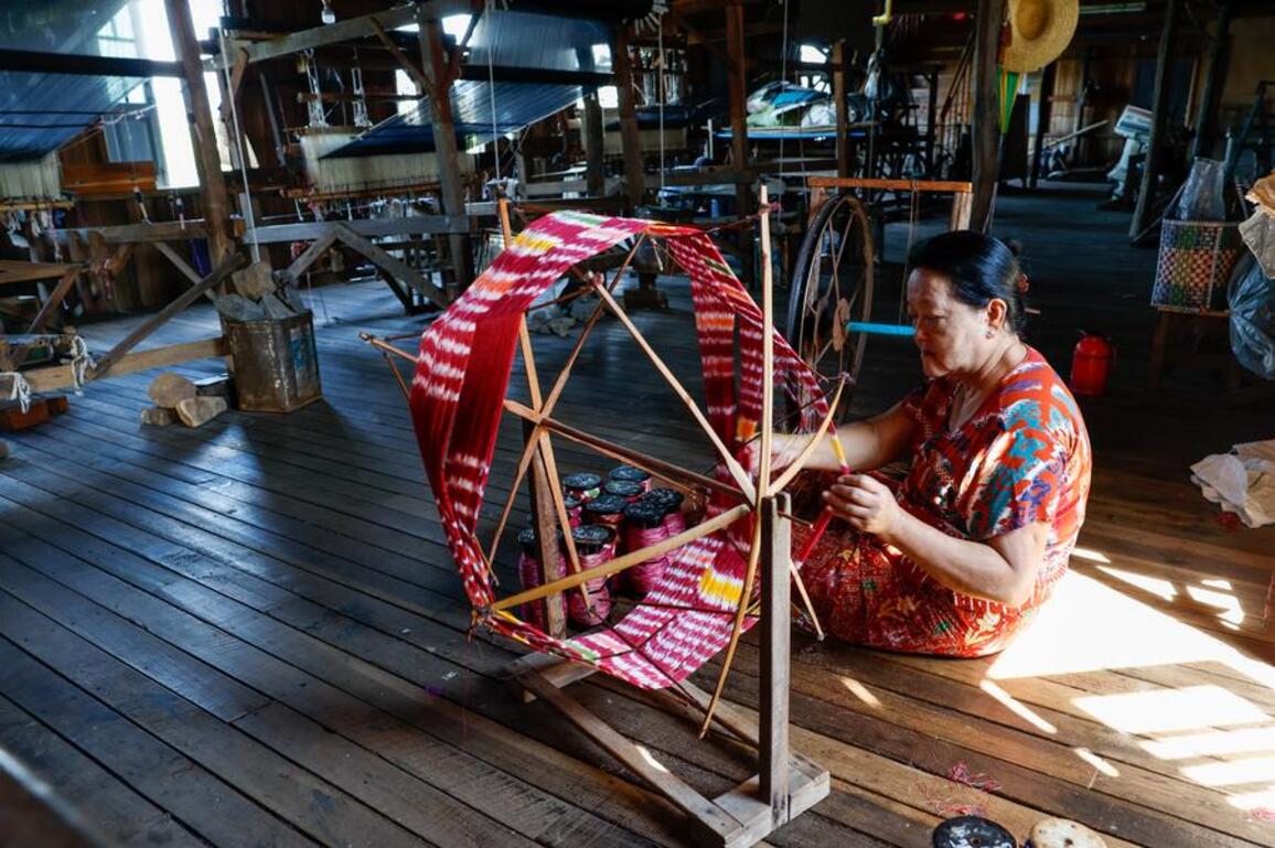 With patient hands, Myanmar's Inthas weave lotus fibers into world's handcrafted luxury