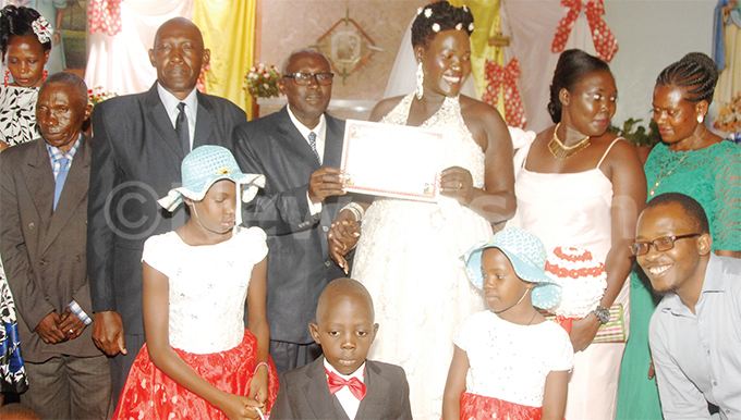  he couple with their children in front after signing their marriage certificate