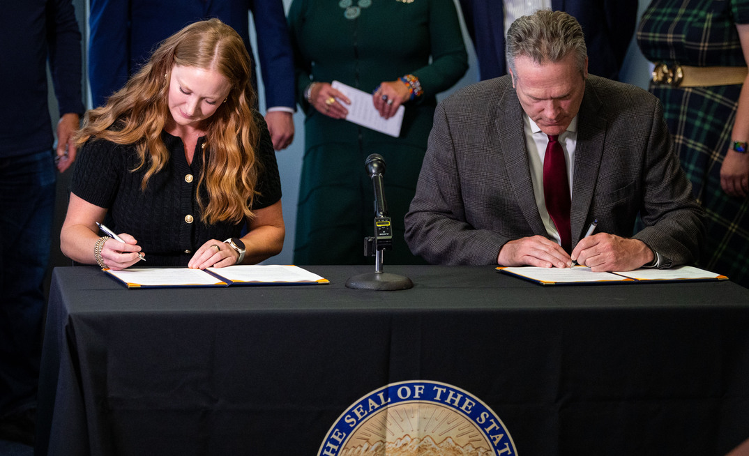 Alaska governor Mike Dunleavy and Permitting Council executive director Emily Domenech sign the MOU