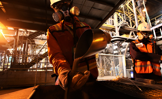 SOROWAKO, INDONESIA - AUGUST 1, 2019: A worker shows the results of the production of nickel ore.