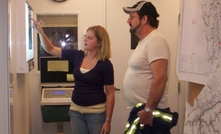 An X-ray technician explaining the basics of a chest X-ray to a coal miner in Harlan County, Kentucky