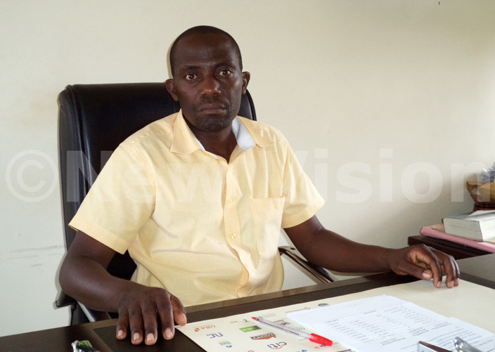  aloke hristian igh chool head teacher ugabi sebuliba in his office
