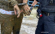 Man arrested after falling 'neck deep' into slurry pit during police chase
