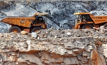 Meeting of mines: Trucks pass at Endeavour Mining's Agbaou mine in Cote d'Ivoire