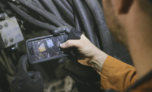  A worker uses a smartphone device down one of the deepest mines in the world, Kidd metals mine in Canada, operated by Glencore