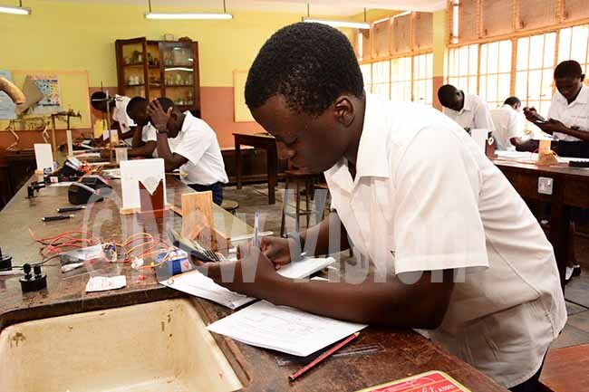   tudent calculating during a  physics practical on onday 4 candidates kicked on their   exams with physics practical hoto by imothy urungi