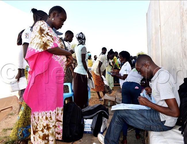  outh udanese efugees with pecial eeds recieving money in mvepi ettlement ladys ida benefited from the support as a single mother to her child hoto y obert riaka1