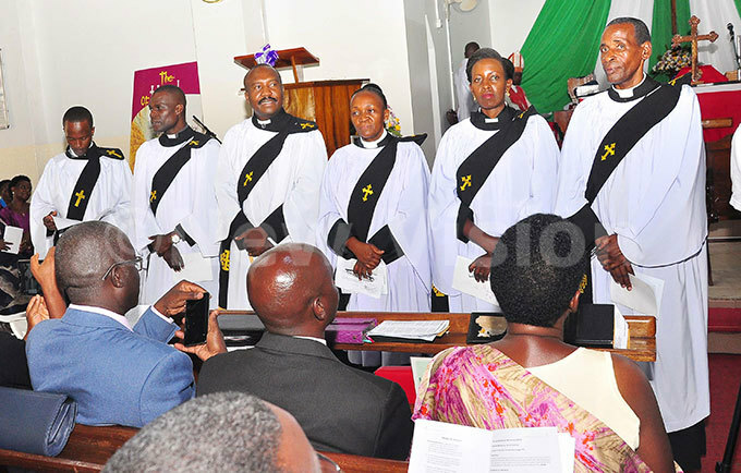  ross section of ordained priests stands before hristians before taking an oath during the ordaining of deacons and priests at ll aints athedral hoto by uliet asirye