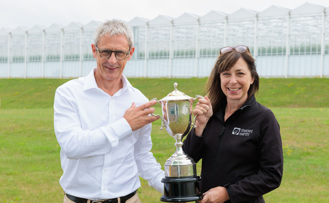 Rob James and Sally Channon with the CLA Emsden Trophy the company won for its environmental and conservation work.
