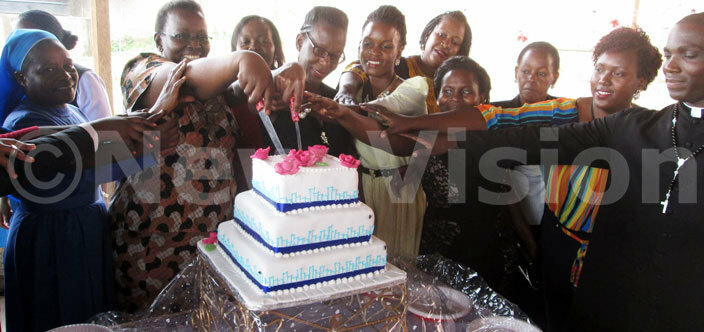  embers of the newly elected executive of ubaga irls  alumni association cut the cake