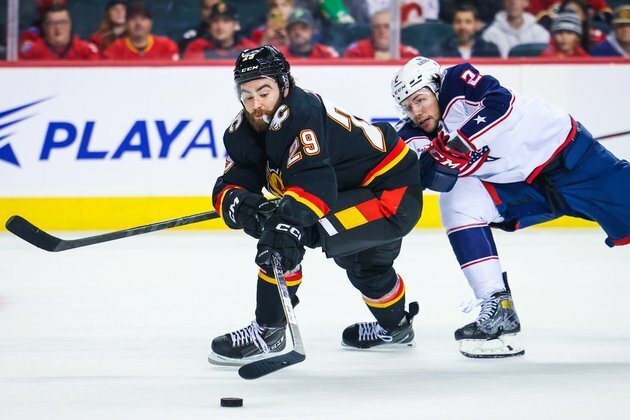 Flames squander two leads before beating Jackets in OT