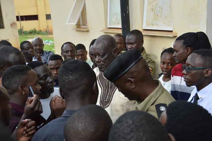 tudents engage the  t ol ames wesigye outside his office hoto by dolf yoreka