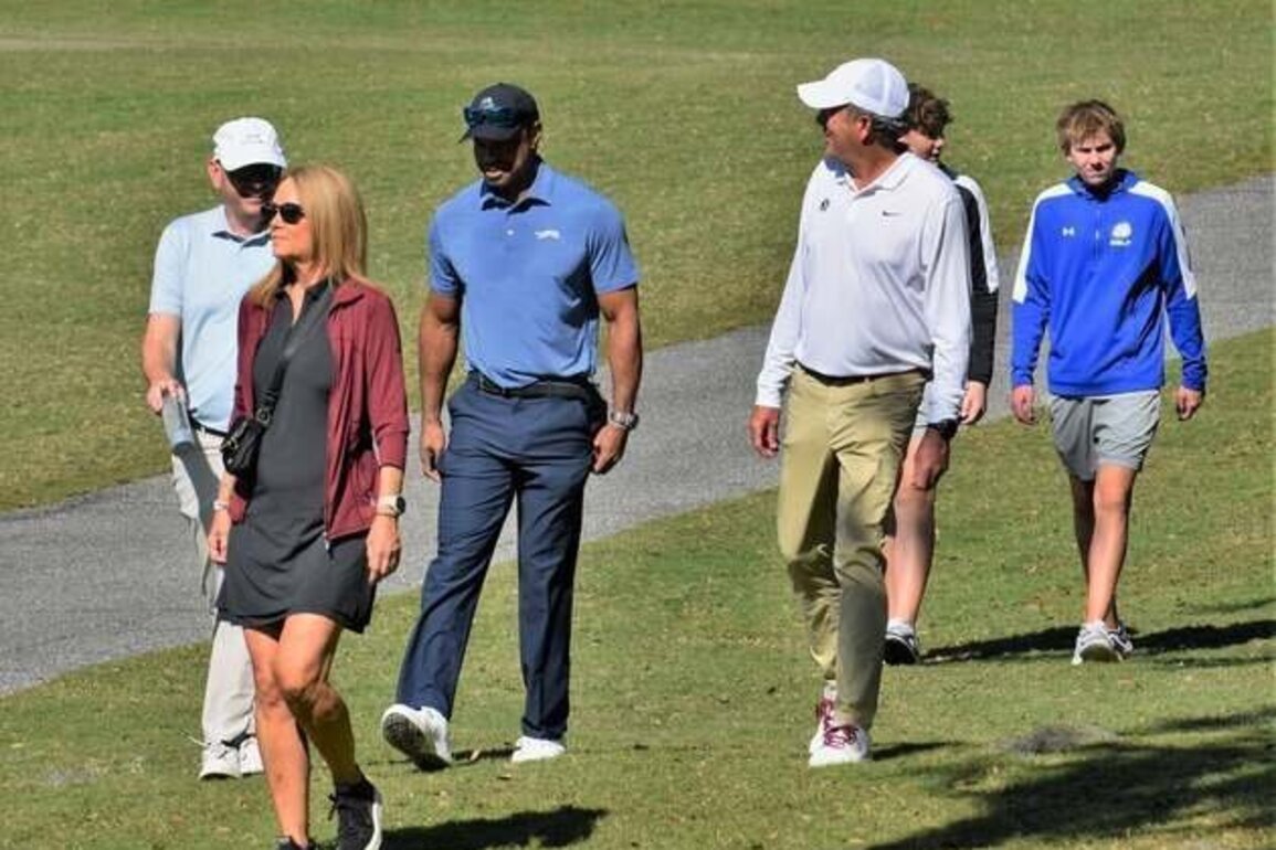 Line forming to recruit Charlie Woods ('27) with Tiger along for ride