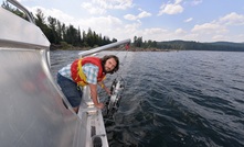 UNBC researcher Sam Albers collects samples at Quesnel Lake