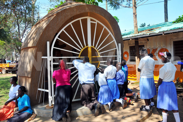  hristians praying at the lottal of t runo serunkuma at amugongo