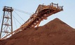Iron ore gains as base metals slip