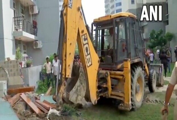 UP: Bulldozers demolish illegal construction at home of man who misbehaved with woman at Noida society