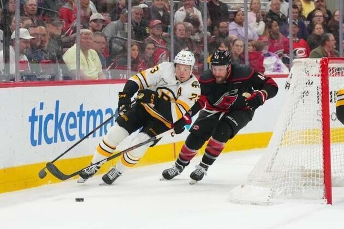 Hurricanes edge Bruins in OT to clinch division title
