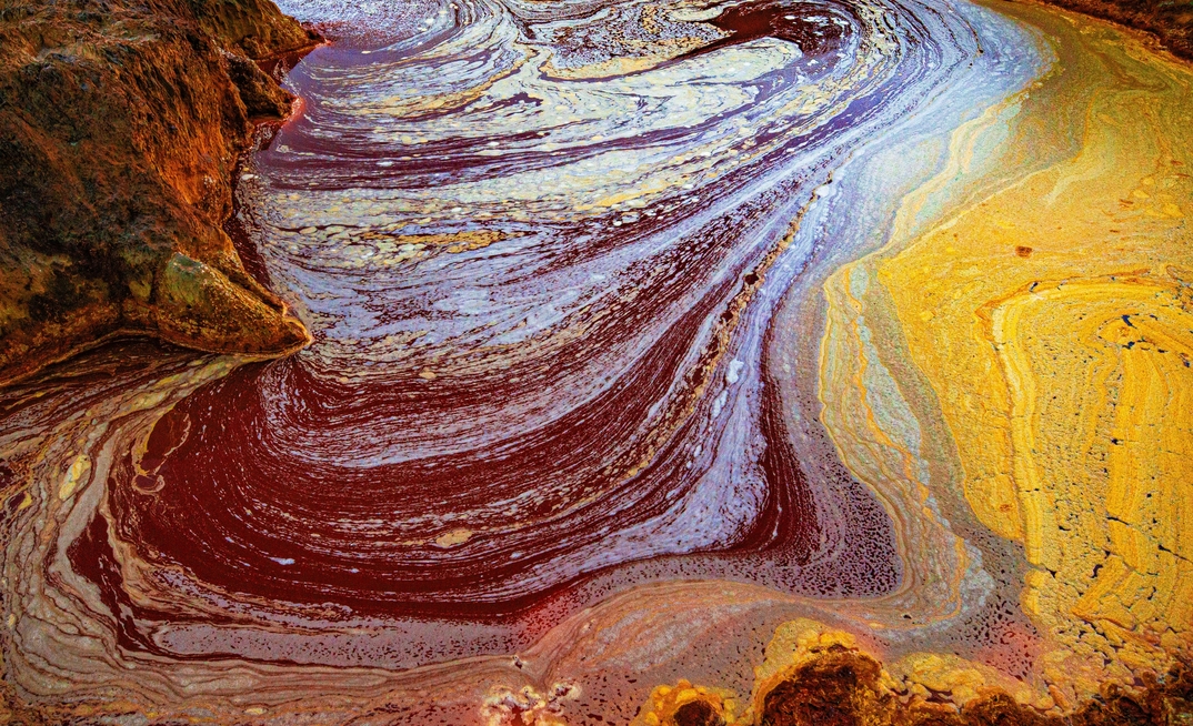 A palette of colors produced by the various metals extracted through mining and bacterial activity in the acidic waters of the river Tinto at its headwaters.
