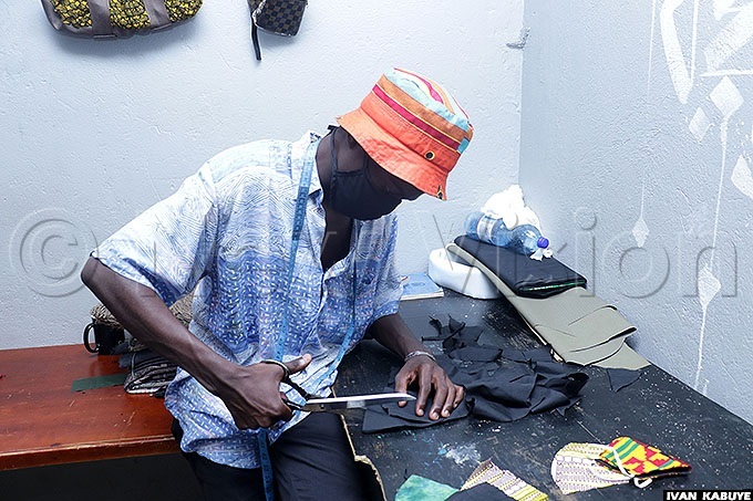  ulondo ustafa cutting a cloth to make masks
