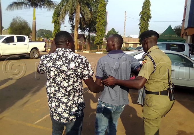 ne of the councillors is led away by a olice officer hoto by bu atuusa