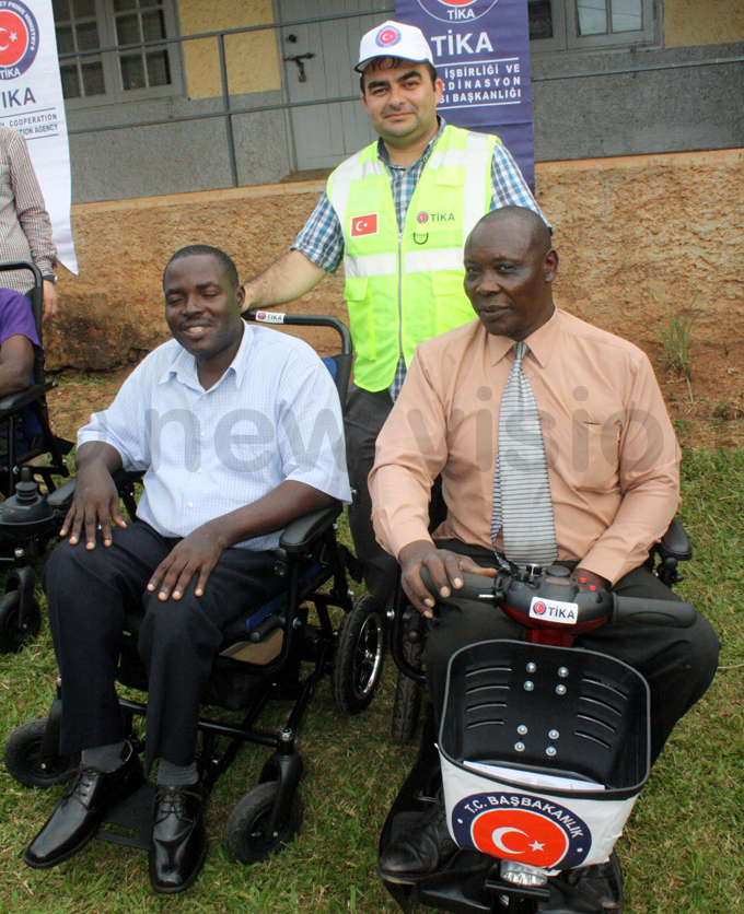 ome of the members of ulago isabled enter receiving new motor wheel chairs hoto by eddie usisi