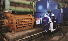 Marthinusen & Coutts technical personnel inspecting oil levels on a 3,300kW pump motor