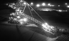 A night shot of a stacker at BHP's Newman iron ore operation.