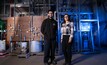 Patrick Mankarious and Maritza Valencia Bejarano stand in front of the autoclave