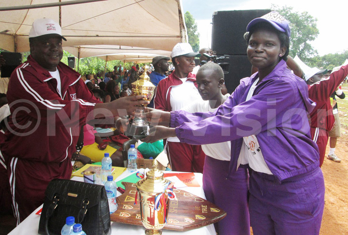  r ornelius sempala hands over the trophy members of ecilia ouse who took second position during the schools platinum jubilee sport gala