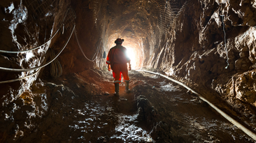 Miner inside the access tunnel of an underground gold and copper mine.