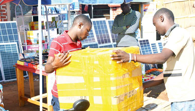  customer buying a solar battery to power his solar system in djumani own hoto by erald enywa