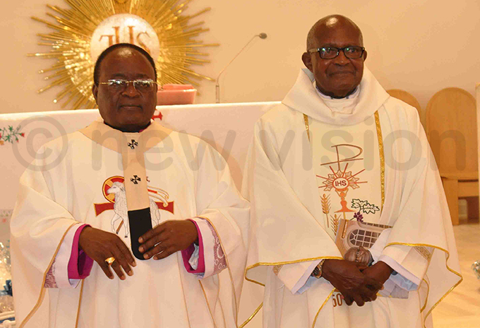rchbishop wanga with r hristopher iwanuka after the mass hoto by uliet ukwago