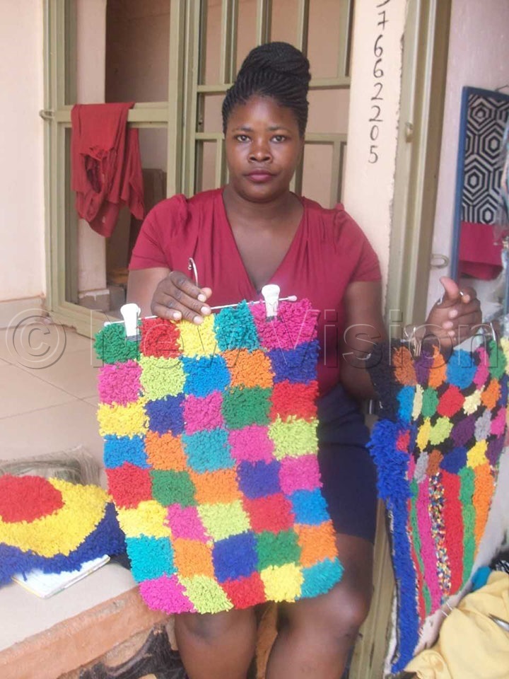 Kiggundu making a door mats