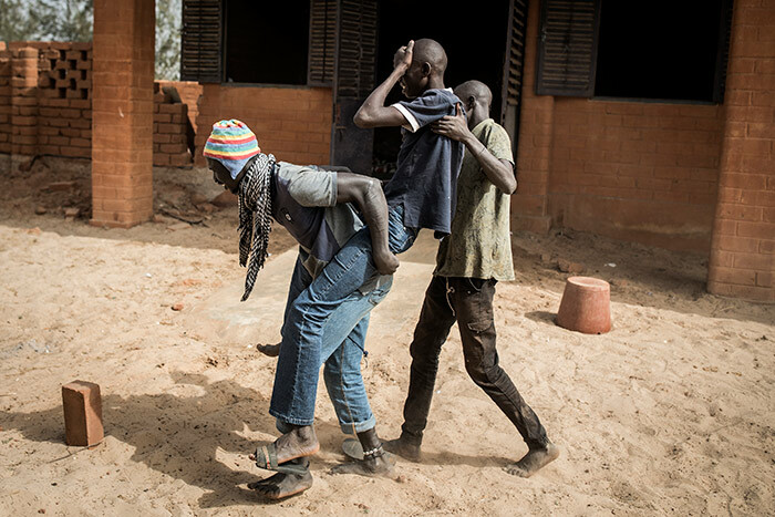   young homeless man who is thought to be suffering from malnutrition is carried to the clinic in a quarantined area at a refuge for newly arrived street children outside akar on pril 10 2020
