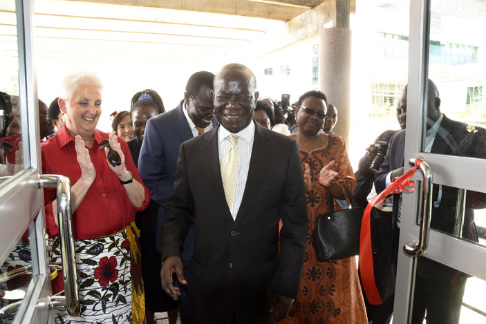  dward iwanuka ekandi smiles as health minister ane uth ceng and  ambassador to ganda eborah alac look on after launching the  facility 
