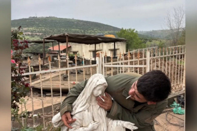 IDF soldier puts cigarette in Virgin Mary statues mouth