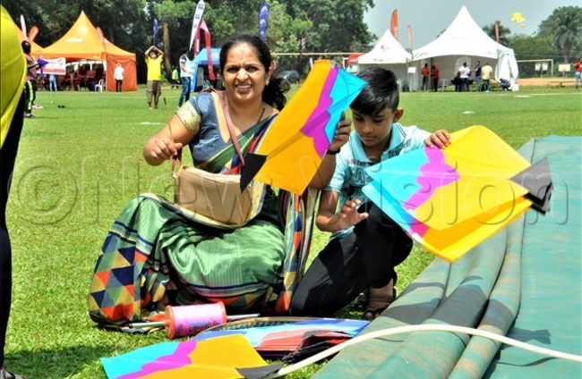   mother and her child making their kite hoto by y eagan sempijja