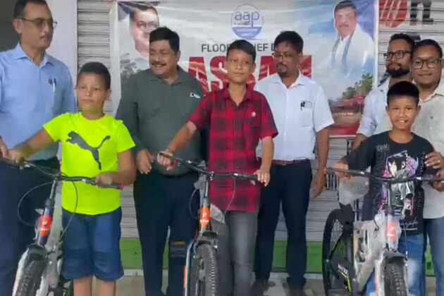 Assam: AAP's Sanjay Singh provides bicycles to flood-hit students, computers to schools in Sivasagar