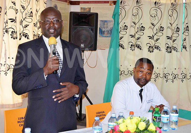  r mmanuel atiibwe with microphone delivers his message as r ndrew ekitoleko listens