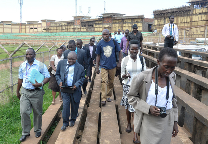 s and  officials inspect akivubo tadium last year to find out how much land was left for sports after am had constructed shops near the ark ard market hoto by ichael subuga