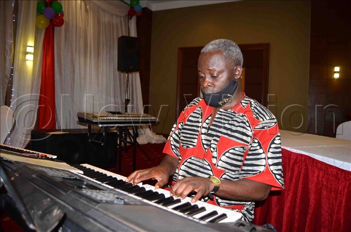 Producer Robert Ssegawa accompanying one of the choirs