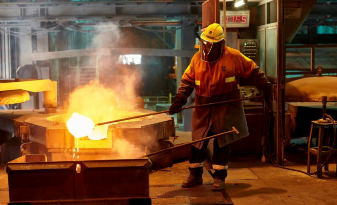 A worker pours molten aluminium at Tomago smelter, as the facility battles soaring power costs and seeks government support.