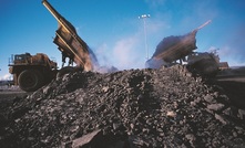 Trucks at Suncor Energy's mine deliver oil sands to the ore preparation plants