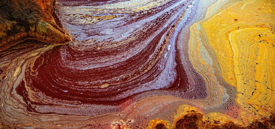 A palette of colors produced by the various metals extracted through mining and bacterial activity in the acidic waters of the river Tinto at its headwaters.