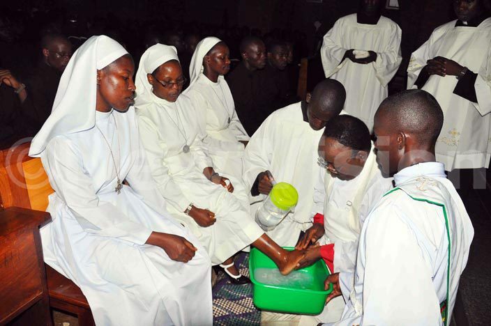   rchbishop r yprian izito wanga washes the foot of ister artha amugabo at t baagas emianrary on oly hursday      